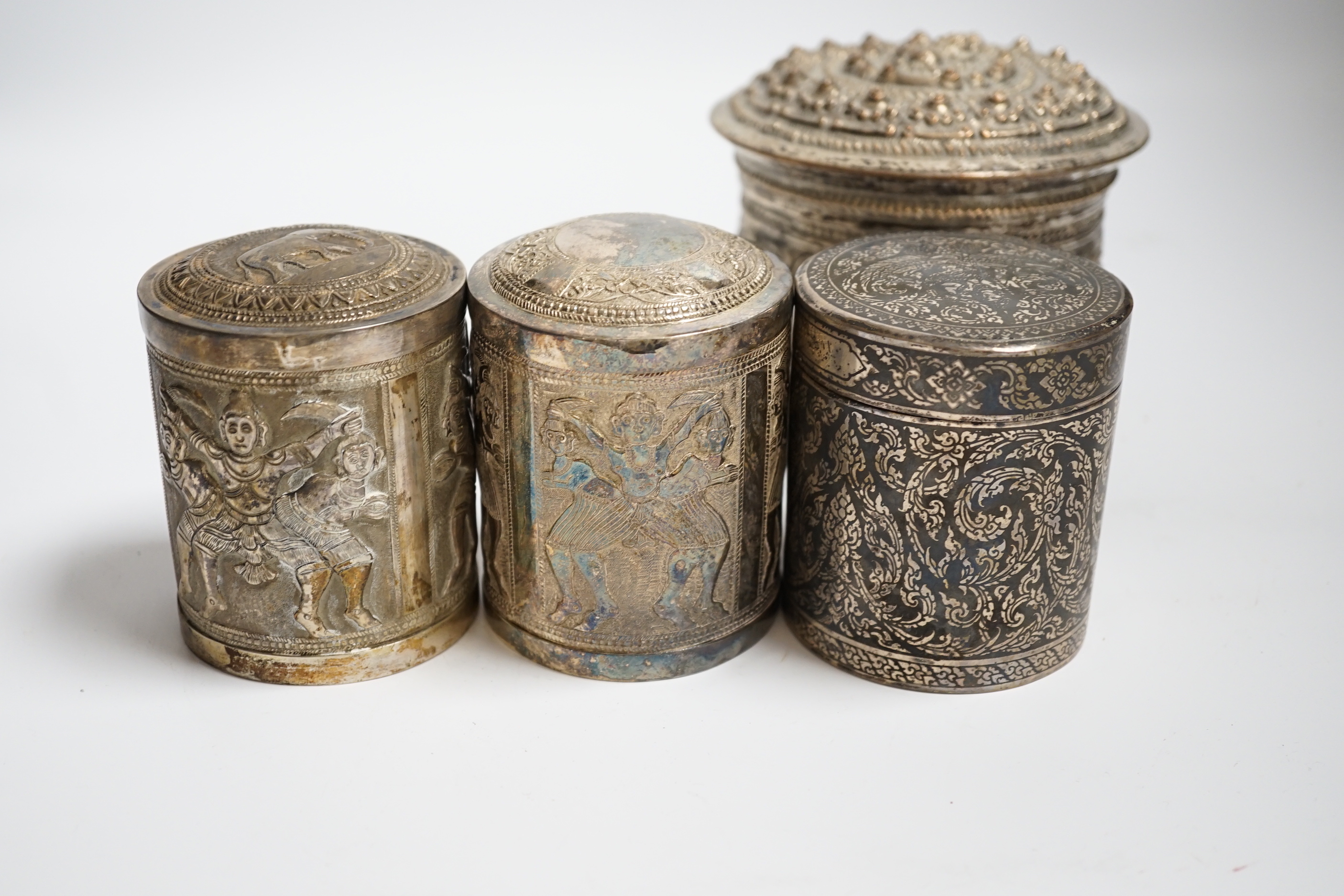 Three Burmese white metal boxes, and a Thai silver and niello work box, tallest 11cm